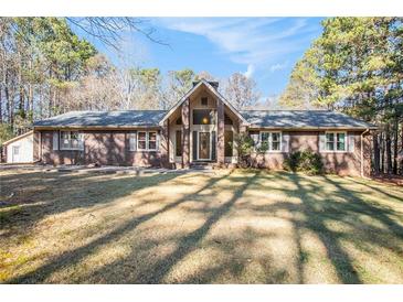 Brick ranch house with a large front yard and mature trees at 4852 Brownsville Rd, Powder Springs, GA 30127