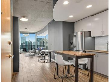 Modern kitchen features stainless steel appliances and granite countertops at 860 Peachtree Ne St # 2513, Atlanta, GA 30308