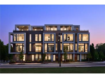 Modern multi-unit building with lighted windows at dusk at 105 Georgia Se Ave # 2, Atlanta, GA 30312
