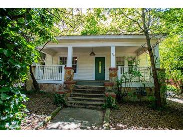 Charming white house with stone accents and a welcoming front porch at 99 Moreland Se Ave, Atlanta, GA 30316