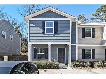 Two-story townhome with gray siding, black shutters, and a small front yard at 2137 Chadwick Road, Atlanta, GA 30331