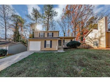 Two-story house with attached garage and landscaped yard at 2089 Glenwood Downs Dr, Decatur, GA 30035