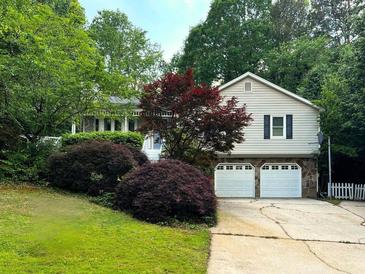 Charming home featuring stone accents, an attached two-car garage, and a well-maintained front lawn at 6389 Grafton Dr, Austell, GA 30168