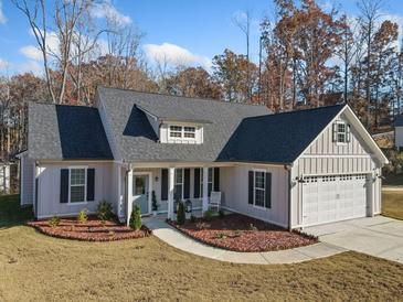 Craftsman style home with gray siding, dark shutters, and a two-car garage at 754 Somersby Dr, Dallas, GA 30157