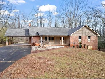 Brick ranch house with carport and spacious yard at 5262 Keithwood Dr, Cumming, GA 30040