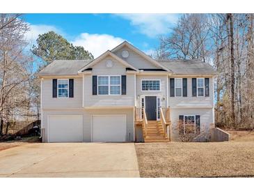 Two-story house with gray siding, two-car garage, and a wooden staircase leading to the front entrance at 66 Trevor Way, Temple, GA 30179