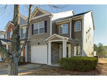 Two-story townhome with stone accents and a two-car garage at 962 Pierce Ivy Ct, Lawrenceville, GA 30043