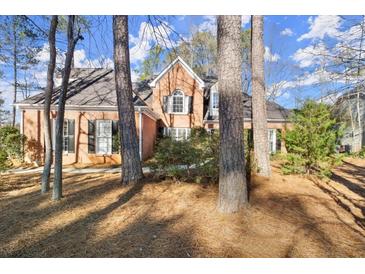 Brick home with landscaped yard and large trees at 1772 Benningfield Dr, Marietta, GA 30064