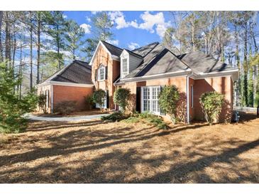 Brick house with mature landscaping and a large front yard at 1772 Benningfield Dr, Marietta, GA 30064