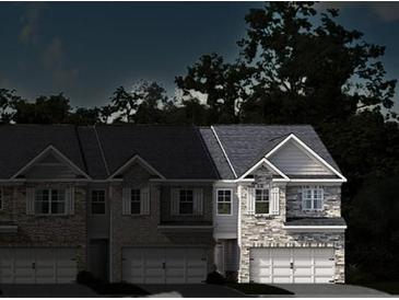 Two-story townhouses with stone accents and two-car garages at 3201 Greyton Dr, Buford, GA 30519