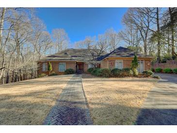 Brick house with landscaped yard and walkway at 325 Yellowroot Ln, Sandy Springs, GA 30350