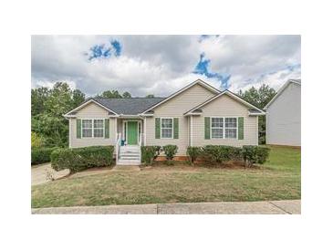 Ranch style home with green accents and landscaped yard at 121 Millwheel Dr, Villa Rica, GA 30180