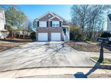 Brick house with two-car garage and a landscaped yard at 2770 Stony Place Ct, Grayson, GA 30017