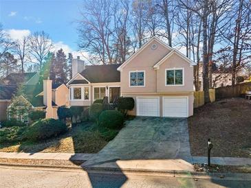 Two-story house with a two-car garage and manicured lawn at 1379 Chatley Way, Woodstock, GA 30188