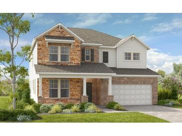 Two-story house with stone and shingle accents, a two-car garage, and landscaping at 3249 Shirecrest Ln, Dacula, GA 30019