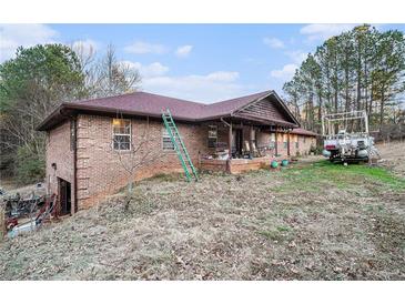 Brick ranch house with a large yard and attached garage at 4055 Thaxton Rd, Atlanta, GA 30349