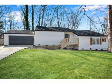 Charming ranch-style home with a well-maintained lawn and a detached garage at 3251 Stoney Acres Nw Dr, Kennesaw, GA 30152