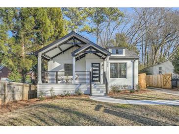 White house with black accents, front porch, and landscaped lawn at 668 Stokeswood Se Ave, Atlanta, GA 30316