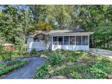 Charming ranch home with a screened porch and landscaped yard at 4660 Whispering Woods Dr, Cumming, GA 30040