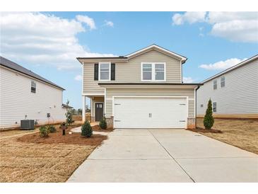 Charming two-story home featuring a two-car garage and a well-manicured lawn in a modern community at 2028 Avalon Rdg, Conyers, GA 30013