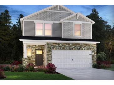 Two-story home with stone accents and a two-car garage at 2030 Avalon Rdg, Conyers, GA 30013