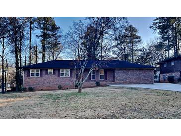 Brick ranch house with a large front yard and mature trees at 4129 Shorter Way, Decatur, GA 30034