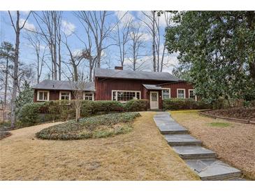 Ranch style home with stone walkway, mature trees, and landscaping at 3781 Narmore Ne Dr, Atlanta, GA 30319