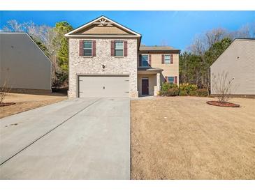 Two-story house with brick and siding, a two-car garage, and a landscaped yard at 1752 Alford Dr, Jonesboro, GA 30236