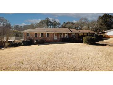 Brick ranch home with carport and spacious yard at 2963 Thompson Cir, Decatur, GA 30034