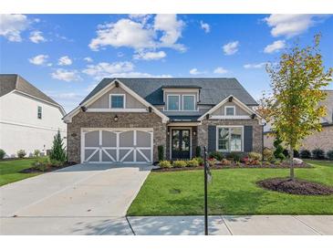 Beautiful two-story home with a large front yard and a two-car garage at 3920 Sugarloaf Dr, Cumming, GA 30028