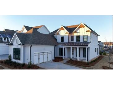 Two-story home with white siding, gray roof, and a three-car garage at 488 Broom Dr, Cumming, GA 30040