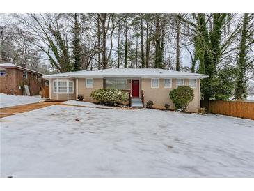 Brick ranch home with a snow-covered yard at 3426 Glensford Dr, Decatur, GA 30032