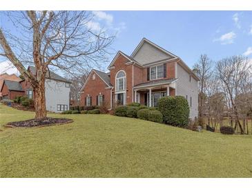 Brick two-story house with gray accents and landscaped lawn at 9706 Spyglass Dr, Villa Rica, GA 30180