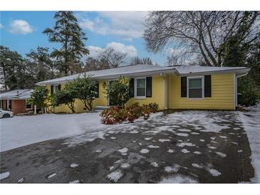 Ranch style home with snow covered yard at 3211 Sandusky Dr, Decatur, GA 30032