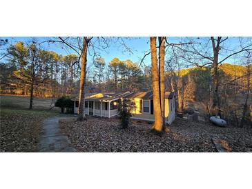 Ranch home on wooded lot with walkway at 710 Seals Rd, Dallas, GA 30157