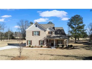 Two-story brick home with front porch and landscaped yard at 860 N Bethany Rd, Mcdonough, GA 30252