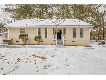 Ranch style home with snow covered yard at 6695 Buckhurst Trl, Atlanta, GA 30349