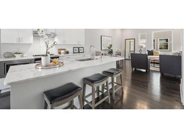 Modern kitchen with island, stainless steel appliances, and white cabinetry at 456 Parkway Ne Dr # 12, Atlanta, GA 30308