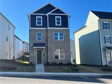 Two-story brick home with dark trim and a small front yard at 1352 Creekside Nw Cir, Atlanta, GA 30318