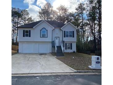 Charming split-level home with a two-car garage and inviting front entrance at 5619 Mayfair Crossing Dr, Lithonia, GA 30038