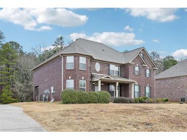 Brick two-story house with landscaping and a driveway at 189 Aylesbury Blvd, Mcdonough, GA 30252