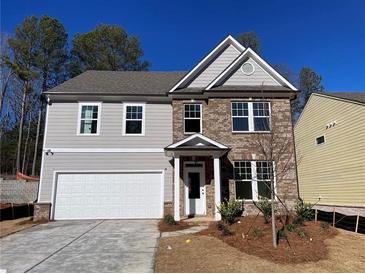 Two-story house with gray siding, brick accents, and a white garage door at 4220 Easter Lily Ave (Lot3), Buford, GA 30519