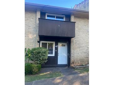 Brick building exterior, featuring a private entrance and landscaping at 1867 Myrtle Sw Dr # 26, Atlanta, GA 30311