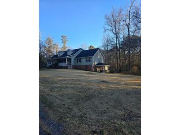 Ranch style home with large yard and covered porch at 2006 Goode Rd, Conyers, GA 30094