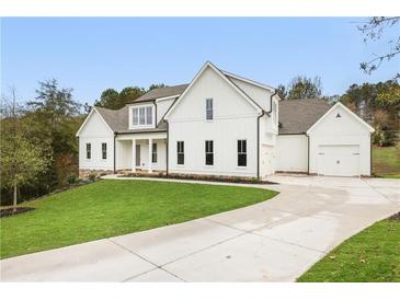 Two-story farmhouse with white siding, gray roof, and a long driveway at 113 Creekview Ln, Canton, GA 30115