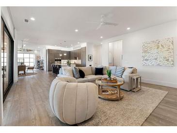 Spacious living room with hardwood floors, large sectional sofa, and stylish coffee table at 1494 Red Fox Ne Dr # D, Atlanta, GA 30306