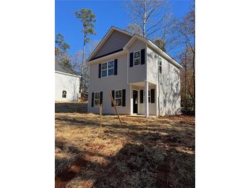 Two-story house with gray siding, black shutters, and a front yard at 2435 Valient Dr, Cumming, GA 30041