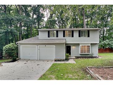 Two-story house with gray siding, two-car garage, and landscaping at 620 Sheringham Ct, Roswell, GA 30076