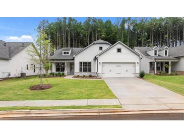 White two-story house with gray stone accents, two-car garage, and landscaped lawn at 320 Sobeck Way, Canton, GA 30115