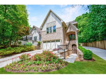 Brick front exterior boasts a charming front porch and beautifully landscaped yard at 1393 Lanier Pl, Atlanta, GA 30306